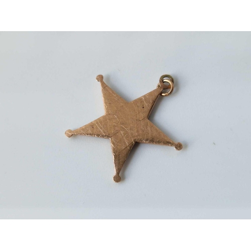 38 - An antique enamel and pearl gold star pendant