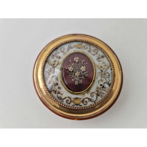 411 - Antique French tortoiseshell circular box with an elaborately decorated top with bows, arrows and fl... 