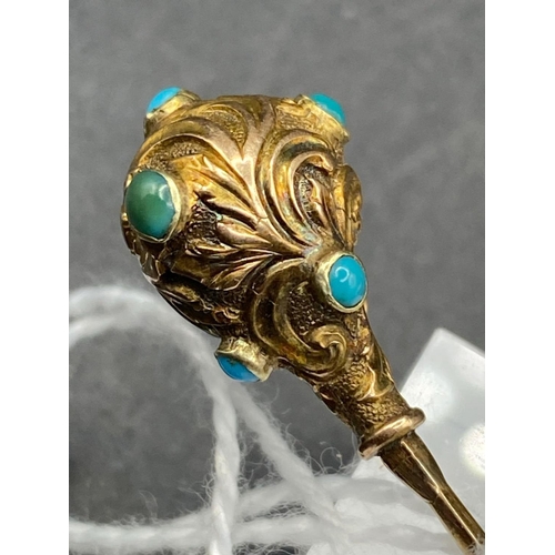 442 - A Victorian scrolled and embossed stick pin set with turquoise in high carat gold