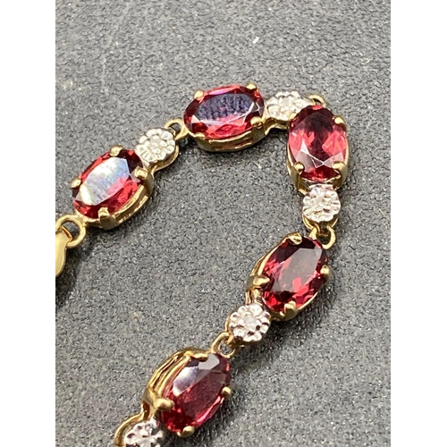 443 - A pretty garnet and diamond bracelet 9ct 7 inch 5 g