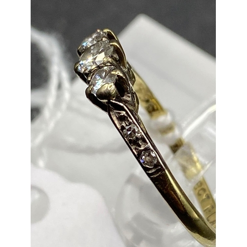 554 - A early 20th century three stone diamond ring with diamond shoulders 18ct gold and platinum size M