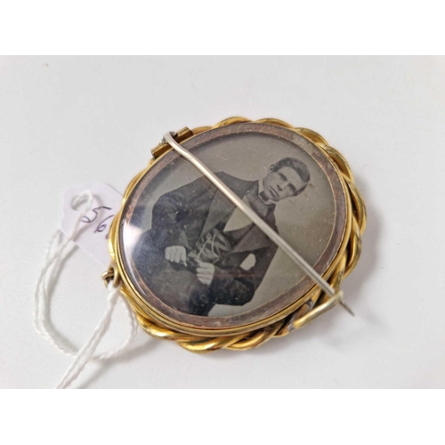 568 - An antique gilt swivel brooch with photo and locket