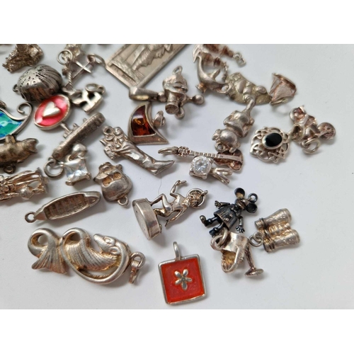 590 - A quantity of silver charms and pendants, 80 g