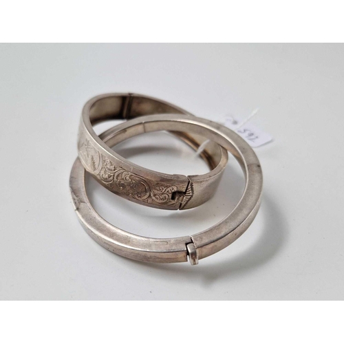 592 - Two hinged silver bangles, 35 g