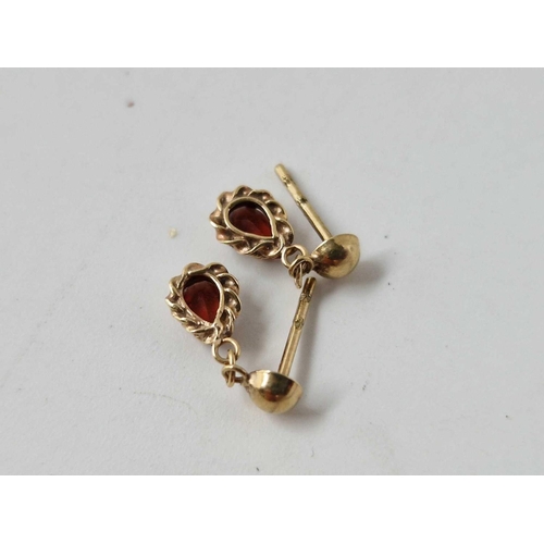 595 - A pair of red stone drop earrings, 9ct