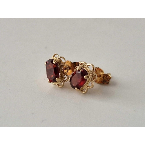 640 - A pair of garnet ear studs, 9ct