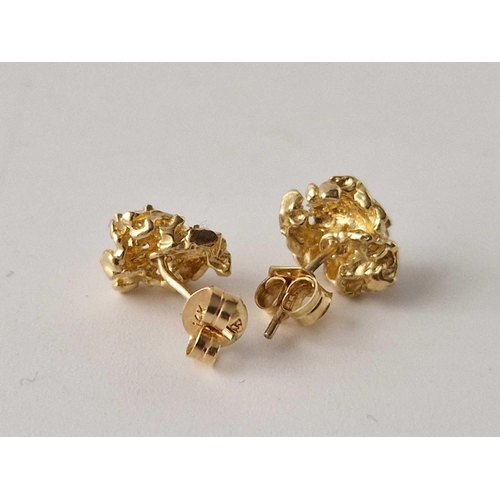 664 - A pair of modernistic white stone ear studs, 9ct, 2 g