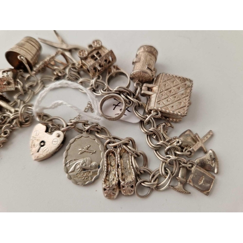 72 - A silver vintage charm bracelet 54.8g