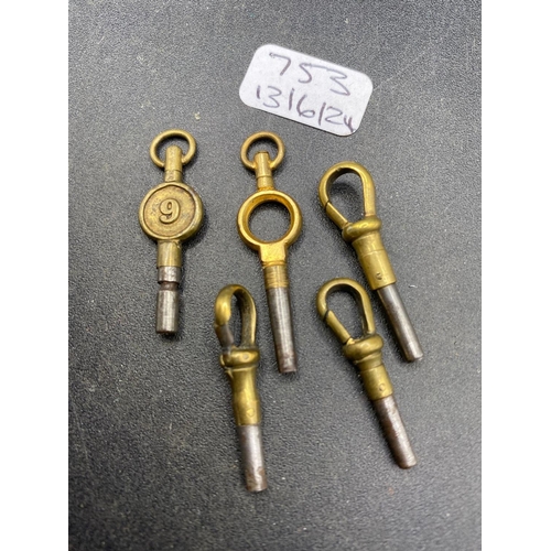 753 - A bag of five assorted watch keys