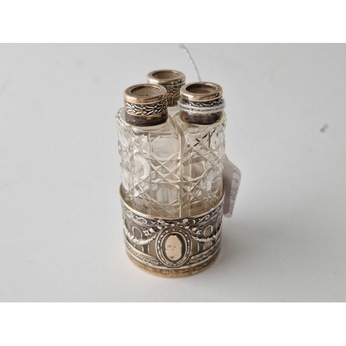 854 - A set of three silver mounted scent bottles in a sleeve, cut glass bodies, 3