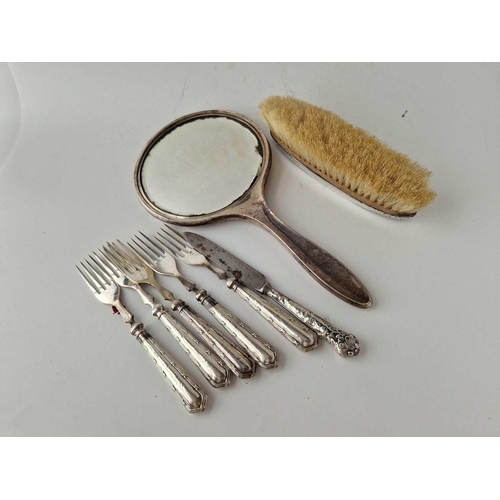 878 - A mounted hand mirror, a brush and silver handled forks