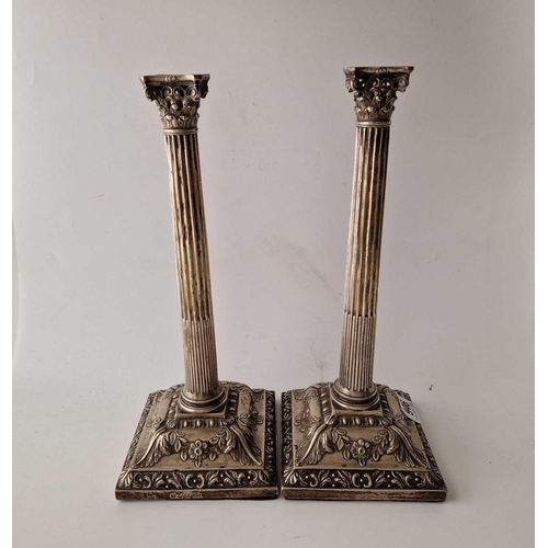 946 - A pair of early George III candle sticks with square bases, fluted stems with corinthian capitals, 1... 