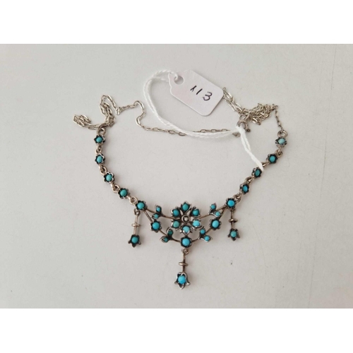 113 - A silver turquoise set fringe necklet with flower design centre