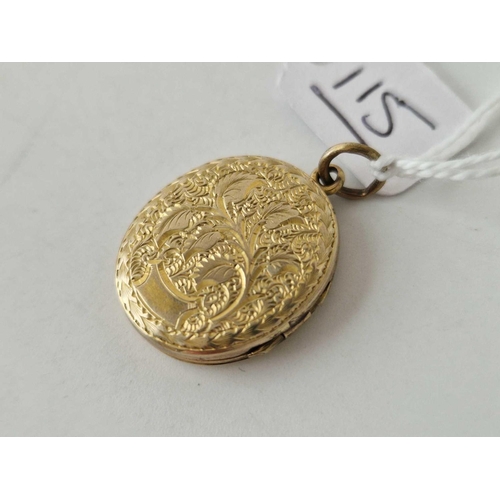 115 - A 15ct gold oval back and front locket with chased decoration