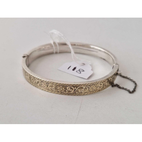 118 - A Victorian silver gold fronted bangle with engraved scroll decoration