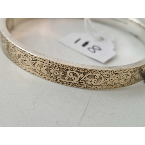 118 - A Victorian silver gold fronted bangle with engraved scroll decoration