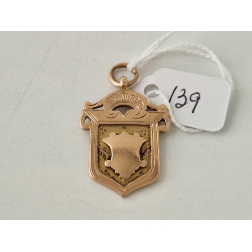 139 - A antique shield shaped fob medallion 9ct 5.5 gms