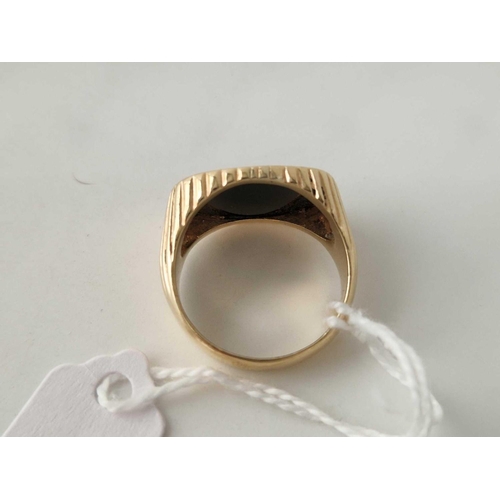 14 - A ONYX SET OVAL SIGNET RING WITH RIBBED DECORATION 14CT GOLD SIZE Q 8.1 GMS