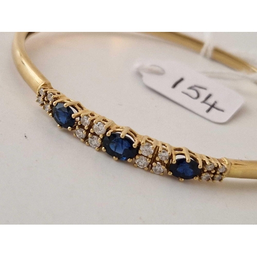 154 - A PRETTY DIAMOND AND SAPPHIRE BANGLE 18CT GOLD 15 g BOXED