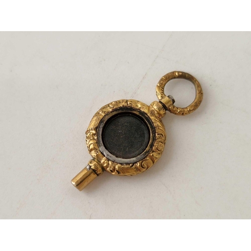 35 - A unusual antique back and front watch key with locket