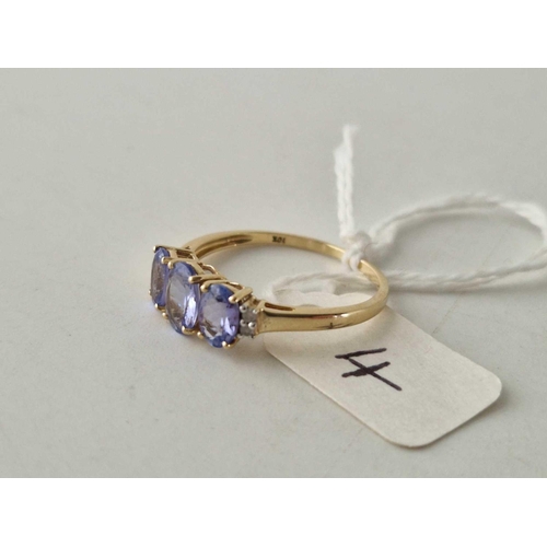 4 - A three stone tanzanite ring with diamond shoulders 10ct gold size S 1.9 gms