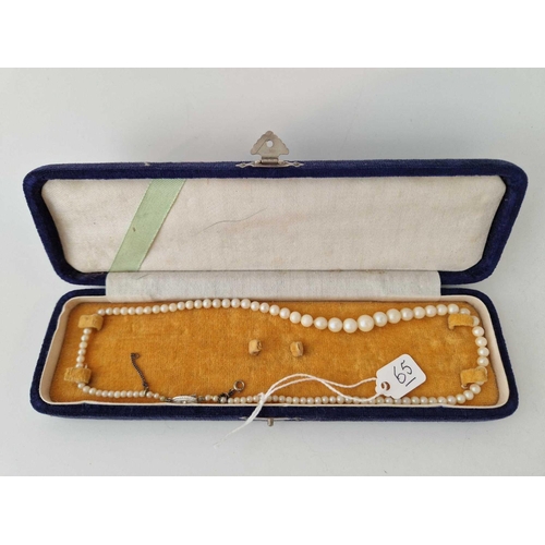 65 - A boxed string of vintage pearls with silver clasp and safety chain