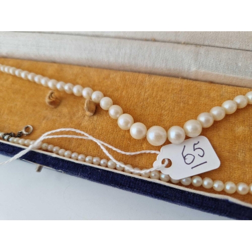 65 - A boxed string of vintage pearls with silver clasp and safety chain