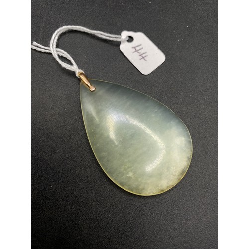 44 - A gold mounted jadeite pendant 21.4 gms