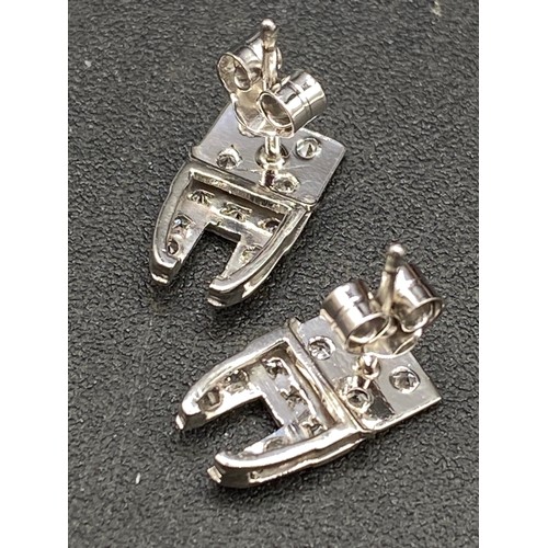 79 - A pair of platinum and diamond stud earrings