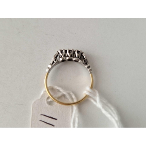 110 - A 18ct gold and platinum three stone ring size L 2.2 gms