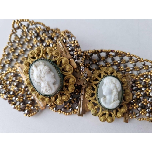 135 - A PAIR OF VICTORIAN WOVEN BEADED BRACELETS WITH GOLD COLOURED AND CUT STEEL BEADS SET WITH A CAMEO T... 