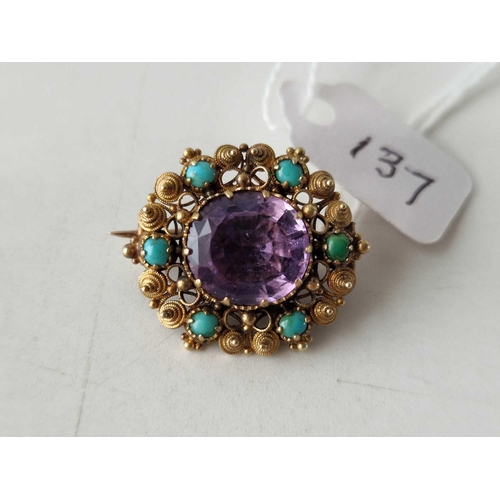 137 - A GEORGIAN GOLD CANNETILLE BROOCH SET WITH SIX TURQUOISE AND A CENTRAL AMETHYST 15CT GOLD