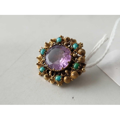 137 - A GEORGIAN GOLD CANNETILLE BROOCH SET WITH SIX TURQUOISE AND A CENTRAL AMETHYST 15CT GOLD