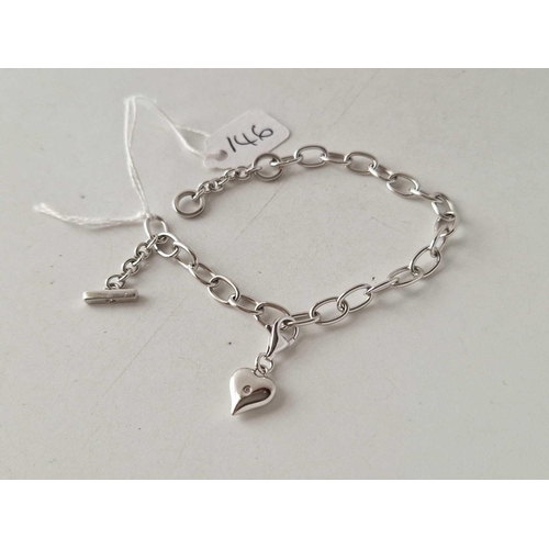 146 - A silver hot diamond charm bracelet with single charm