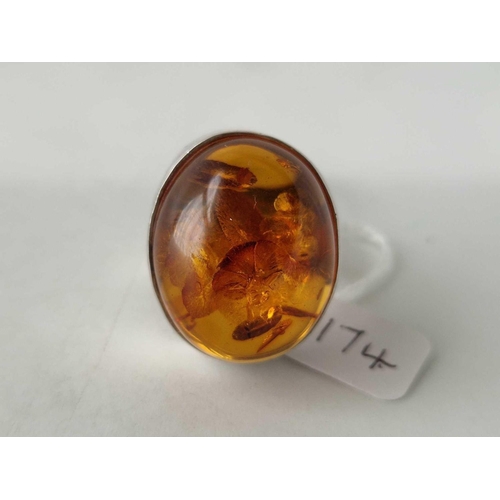 174 - A large silver cabochon amber ring, size Y