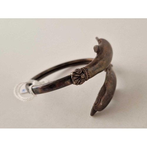 180 - A silver dolphin bangle, 31 g