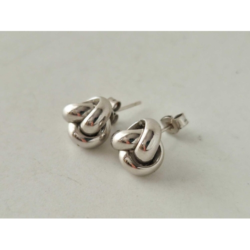 194 - A pair of knot white gold earrings 18ct gold