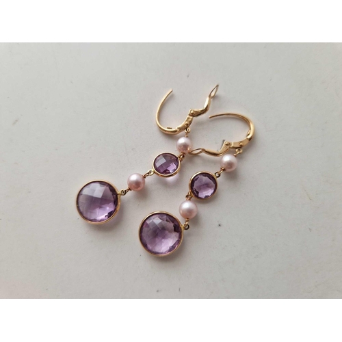 218 - A pair of amethyst and pearl drop earrings, 18 ct