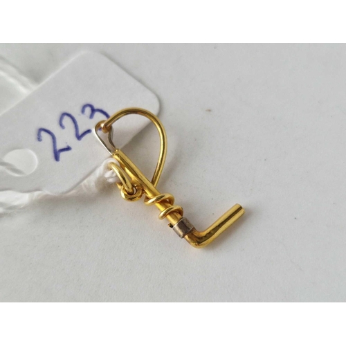 223 - A riding crop charm 9ct