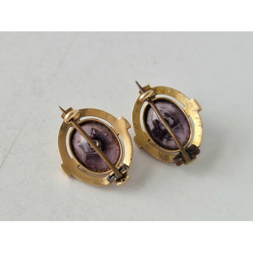 25 - A pair of amethyst brooches with black and white enamel 15ct gold 7.8 gms