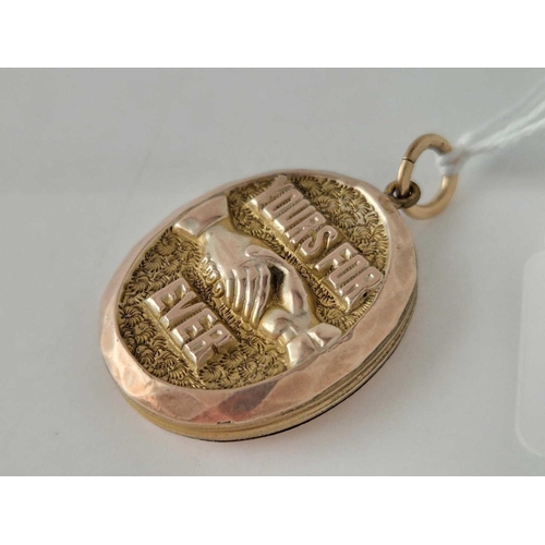 252 - A Victorian novelty gold back and front locket with clasped hands and yours forever