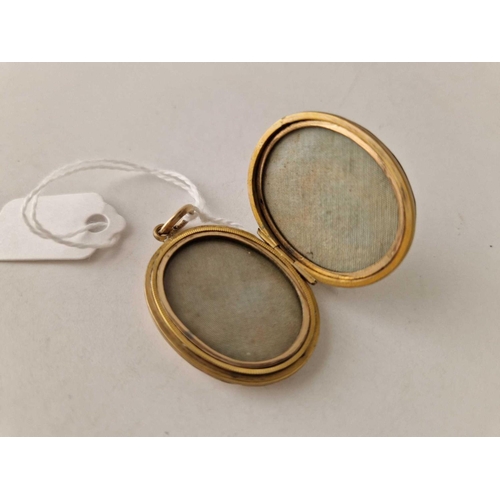 252 - A Victorian novelty gold back and front locket with clasped hands and yours forever