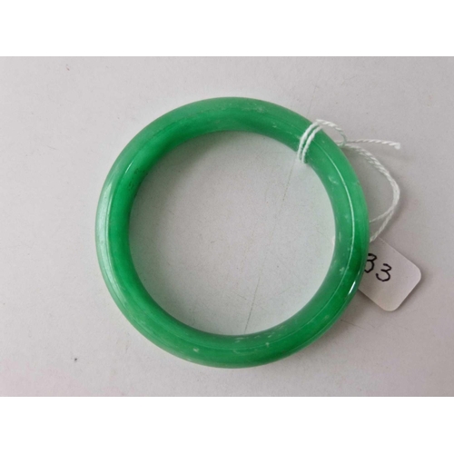 33 - A ANTIQUE GREEN JADE SLAVE BANGLE