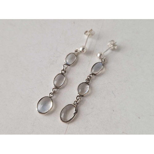 339 - A pair of moonstone drop earrings mounted in silver with silver ear stud fittings