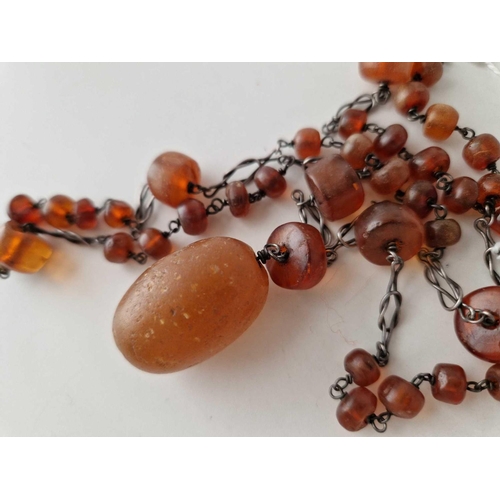 355 - A long arts and crafts silver and amber necklace 30 inch