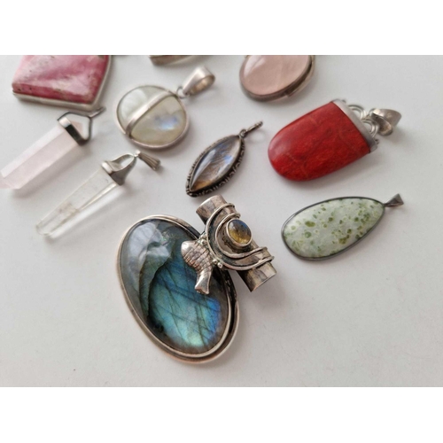 366 - Eleven silver stone set pendants