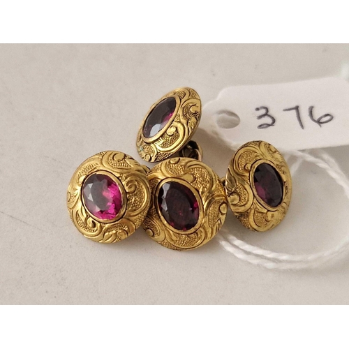 376 - A pair of engraved gold and garnet cufflinks 6.3 gms