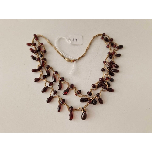 379 - A garnet roundels necklace 13 inch