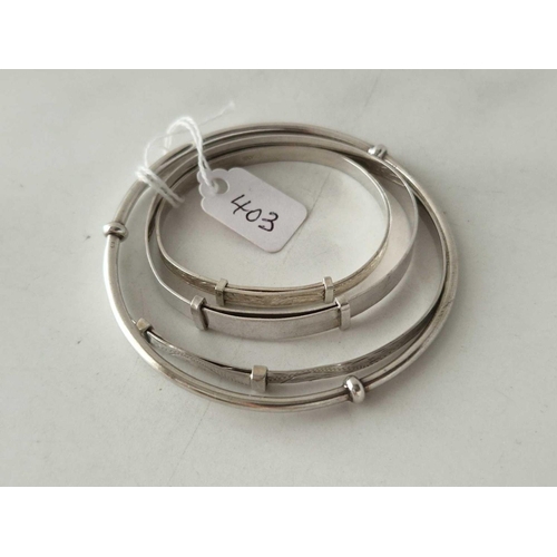 403 - Four silver bangles 18 gms