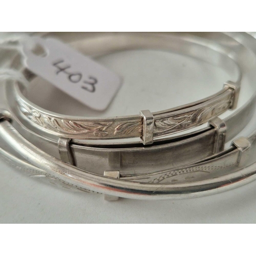 403 - Four silver bangles 18 gms